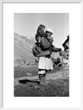 Tajik man carrying a boy on his back