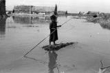 Suaid boy poling a raft
