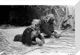 Suaid man and boy weaving mats