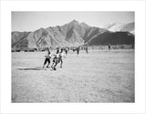 Playing football on a field near the Norbhu Lingka.