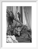View of sailors hoisting sails ...
