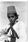 Arab boy wearing a conical hat