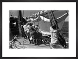 Sailors raising the mainsail