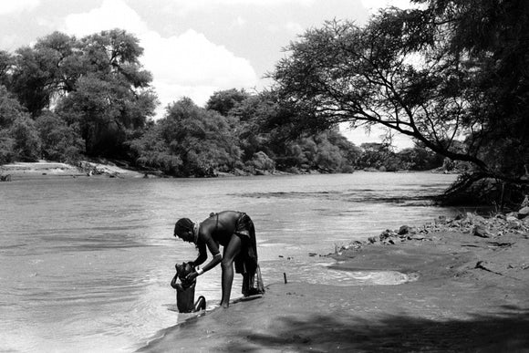 Turkana woman bathing her child