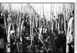 Dinka men with spears at a funeral dance