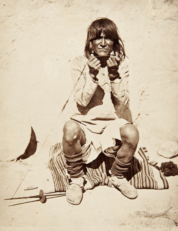 Hopi man spinning yarn