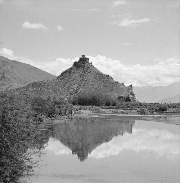 Chakpori reflected in the waters of the Kyichu river