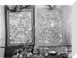 Two Thanka behind altar with offering bowls