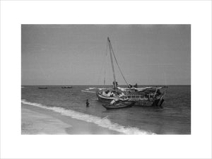 View of men unloading dhows ...